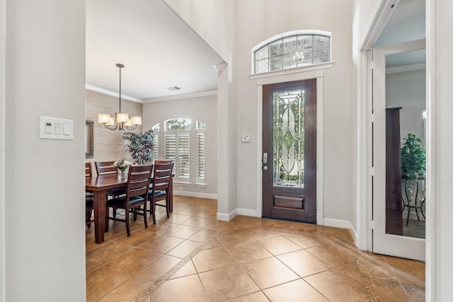 15730 Hunters Lake Way, Houston, TX 77044 - entrance foyer with healthy amount of natural light, a chandelier, tile patterned floors, baseboards, and ornamental molding