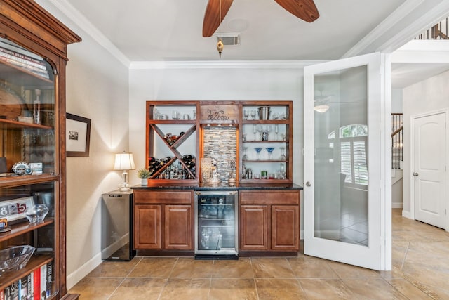 15730 Hunters Lake Way, Houston, TX 77044 - indoor dry bar featuring beverage cooler, ceiling fan, ornamental molding, baseboards, and light tile patterned flooring
