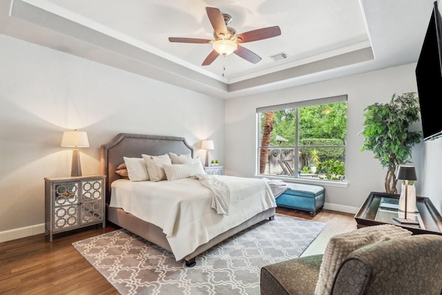 15730 Hunters Lake Way, Houston, TX 77044 - bedroom with a tray ceiling, wood finished floors, baseboards, ornamental molding, and ceiling fan