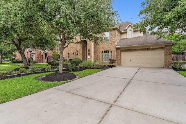 15730 Hunters Lake Way, Houston, TX 77044 - view of front facade featuring brick siding, concrete driveway, a front lawn, and a garage