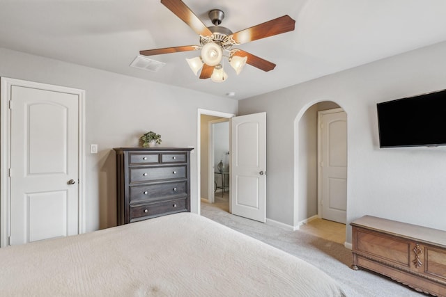 15730 Hunters Lake Way, Houston, TX 77044 - bedroom featuring light colored carpet, arched walkways, baseboards, and a ceiling fan