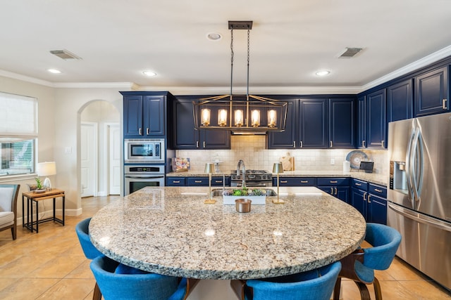 15730 Hunters Lake Way, Houston, TX 77044 - kitchen featuring appliances with stainless steel finishes, a breakfast bar, arched walkways, a sink, and crown molding