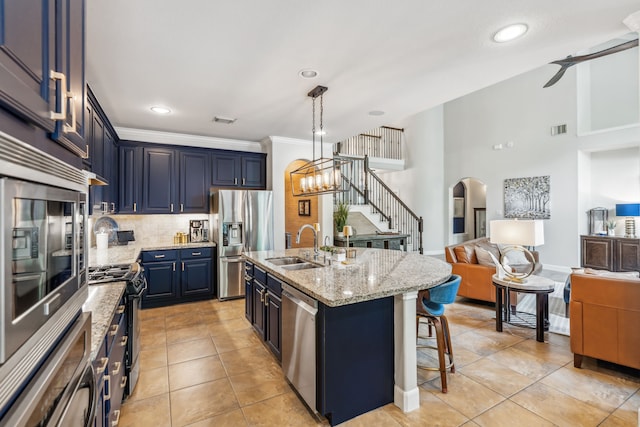 15730 Hunters Lake Way, Houston, TX 77044 - kitchen featuring appliances with stainless steel finishes, open floor plan, backsplash, a sink, and a kitchen breakfast bar