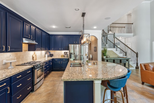 15730 Hunters Lake Way, Houston, TX 77044 - kitchen featuring appliances with stainless steel finishes, a sink, under cabinet range hood, blue cabinets, and a breakfast bar area