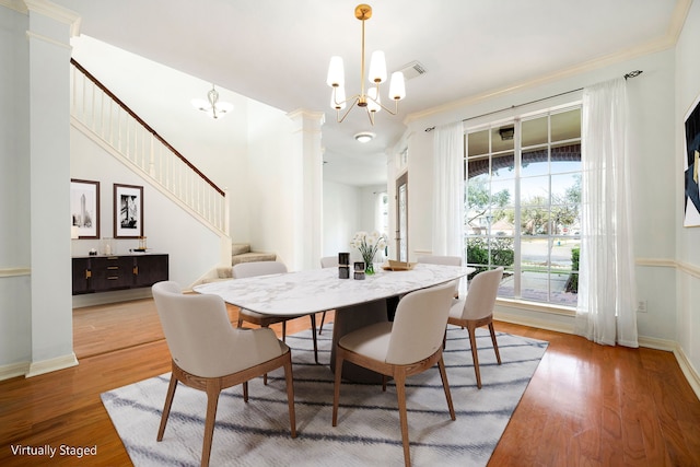 3815 Shadow Knoll Ct, Houston, TX 77082 - dining room featuring ornate columns, stairs, wood finished floors, and a chandelier