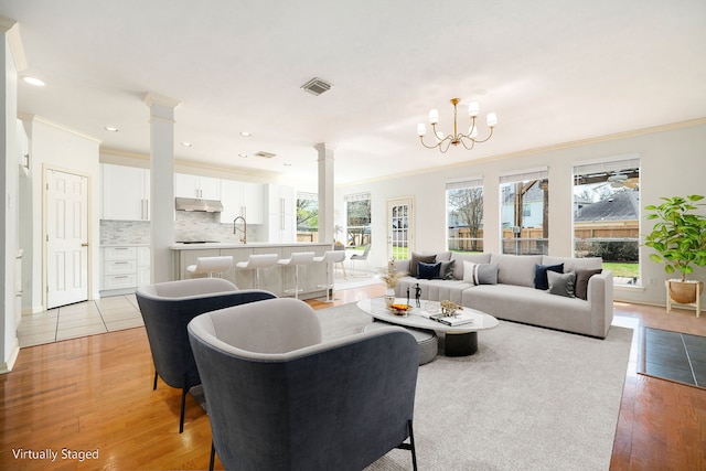 3815 Shadow Knoll Ct, Houston, TX 77082 - living area with decorative columns, ornamental molding, plenty of natural light, light wood-type flooring, and recessed lighting