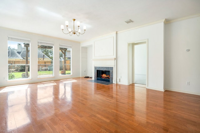 3815 Shadow Knoll Ct, Houston, TX 77082 - unfurnished living room with ornamental molding, a chandelier, wood finished floors, a tile fireplace, and baseboards