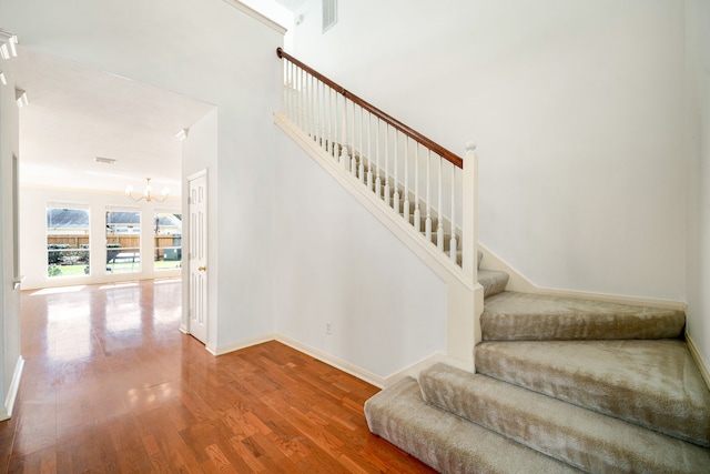 3815 Shadow Knoll Ct, Houston, TX 77082 - stairs featuring a chandelier, wood finished floors, and baseboards