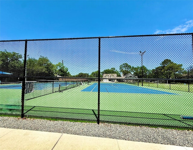 view of tennis court with fence