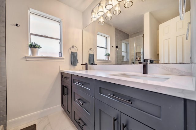 full bath featuring a shower stall, baseboards, double vanity, and marble look tile flooring