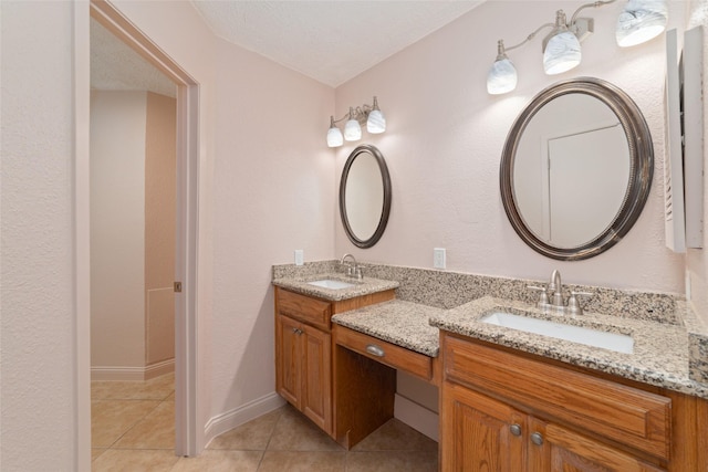 21603 Slippery Creek Ln, Spring, TX 77388 - bathroom with tile patterned floors, two vanities, and baseboards
