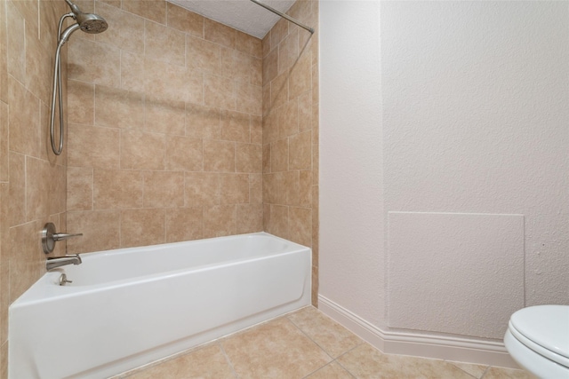 21603 Slippery Creek Ln, Spring, TX 77388 - full bath featuring tile patterned floors, toilet, tub / shower combination, a textured wall, and baseboards