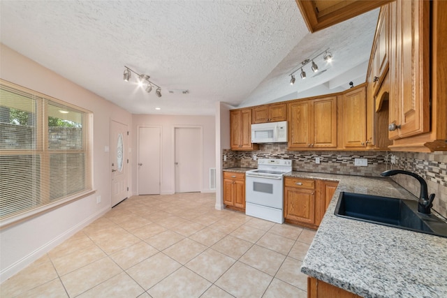 21603 Slippery Creek Ln, Spring, TX 77388 - kitchen featuring white appliances, track lighting, a sink, backsplash, and light tile patterned floors