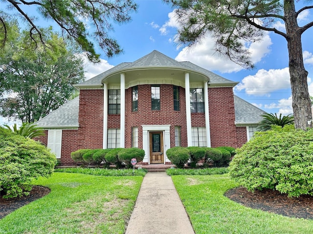 10614 Gold Point Dr, Houston, TX 77064 - view of front of house with brick siding, a front yard, and a shingled roof