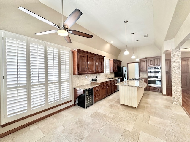 10614 Gold Point Dr, Houston, TX 77064 - kitchen featuring a sink, tasteful backsplash, stone tile flooring, stainless steel appliances, and a ceiling fan