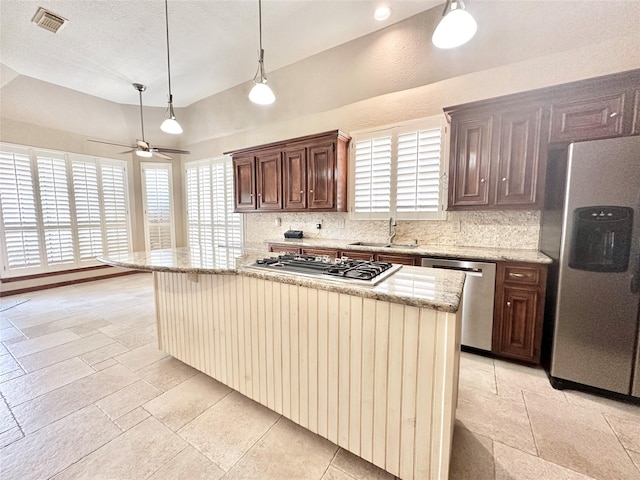 10614 Gold Point Dr, Houston, TX 77064 - kitchen with appliances with stainless steel finishes, a sink, tasteful backsplash, stone tile flooring, and ceiling fan