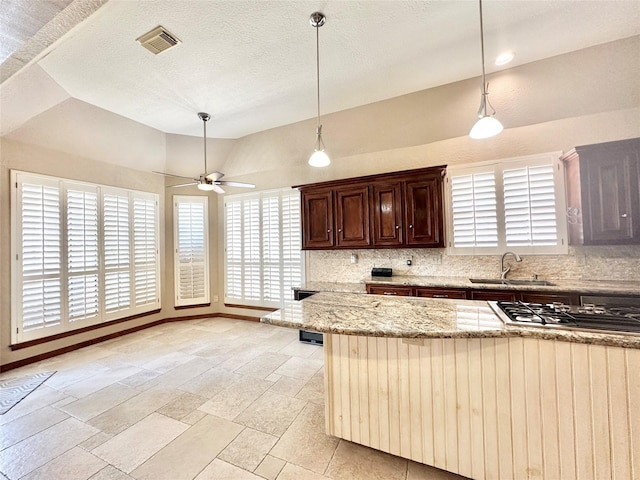 10614 Gold Point Dr, Houston, TX 77064 - kitchen featuring a sink, stainless steel gas cooktop, healthy amount of natural light, tasteful backsplash, and vaulted ceiling