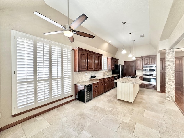 10614 Gold Point Dr, Houston, TX 77064 - kitchen with vaulted ceiling, double oven, backsplash, a sink, and a ceiling fan
