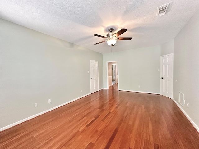 10614 Gold Point Dr, Houston, TX 77064 - empty room with ceiling fan, wood finished floors, baseboards, and a textured ceiling
