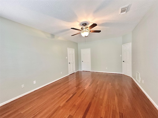 10614 Gold Point Dr, Houston, TX 77064 - spare room featuring wood finished floors, a ceiling fan, baseboards, and a textured ceiling
