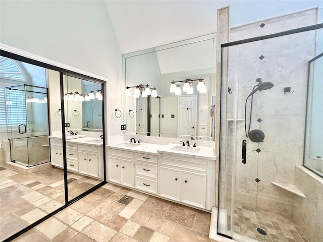 10614 Gold Point Dr, Houston, TX 77064 - bathroom with a stall shower, stone tile flooring, double vanity, and a high ceiling