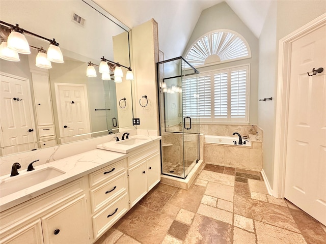 10614 Gold Point Dr, Houston, TX 77064 - full bathroom featuring stone tile floors, a bath, a stall shower, lofted ceiling, and double vanity