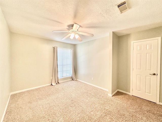 10614 Gold Point Dr, Houston, TX 77064 - unfurnished room featuring ceiling fan, light colored carpet, baseboards, and a textured ceiling