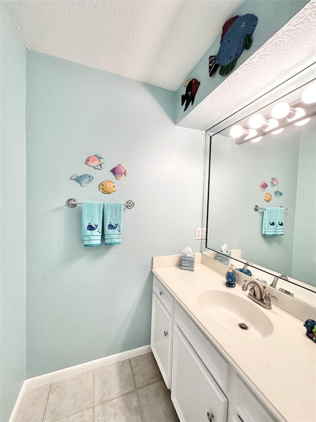 10614 Gold Point Dr, Houston, TX 77064 - bathroom with baseboards, vanity, tile patterned floors, and a textured ceiling
