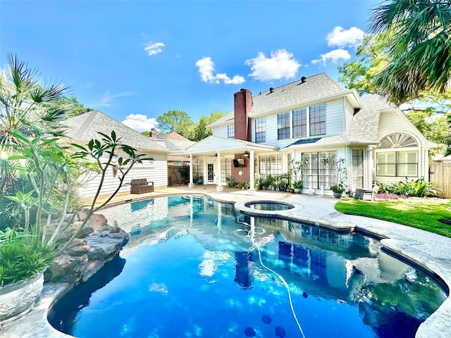 10614 Gold Point Dr, Houston, TX 77064 - view of swimming pool with fence, a patio area, and a pool with connected hot tub