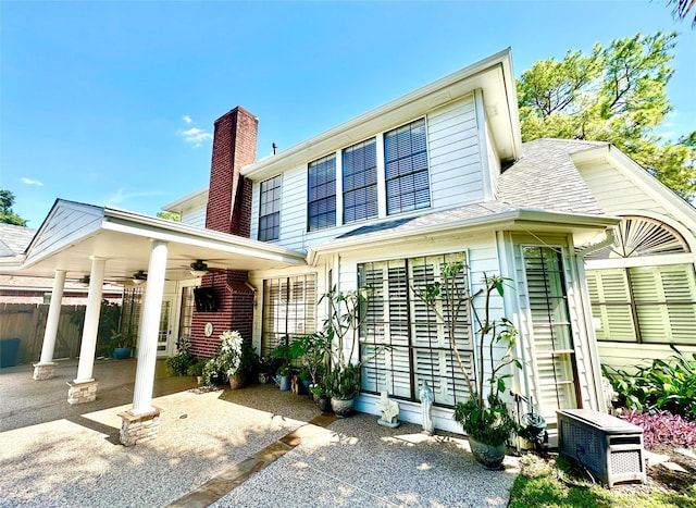 10614 Gold Point Dr, Houston, TX 77064 - view of front of property with ceiling fan, roof with shingles, a chimney, fence, and a patio area
