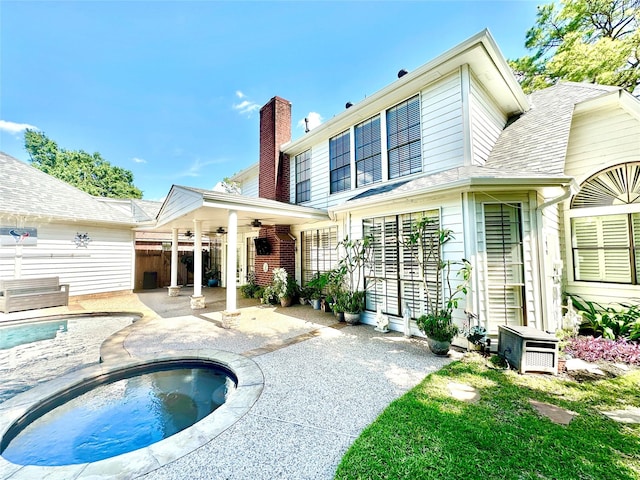 10614 Gold Point Dr, Houston, TX 77064 - rear view of house with a ceiling fan, a patio, an in-ground hot tub, a chimney, and an outdoor pool