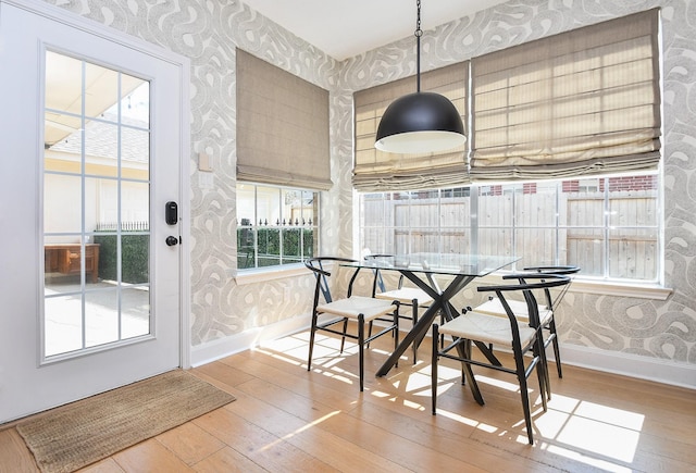 23210 Greenrush Dr, Katy, TX 77494 - dining area with wallpapered walls, hardwood / wood-style flooring, and baseboards
