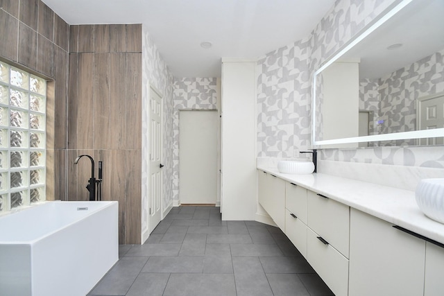23210 Greenrush Dr, Katy, TX 77494 - full bathroom featuring a freestanding tub, double vanity, wallpapered walls, and tile patterned flooring