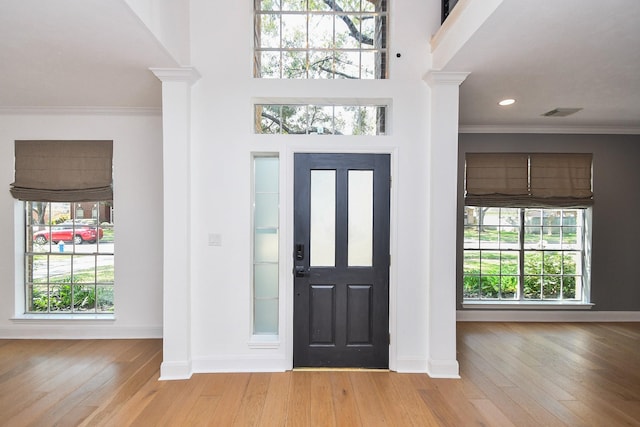 23210 Greenrush Dr, Katy, TX 77494 - foyer entrance with decorative columns, ornamental molding, baseboards, and wood finished floors