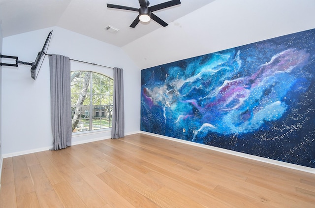 23210 Greenrush Dr, Katy, TX 77494 - spare room featuring wood finished floors, vaulted ceiling, a ceiling fan, and baseboards