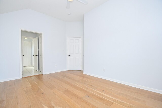 23210 Greenrush Dr, Katy, TX 77494 - empty room featuring light wood-style floors, ceiling fan, baseboards, and vaulted ceiling