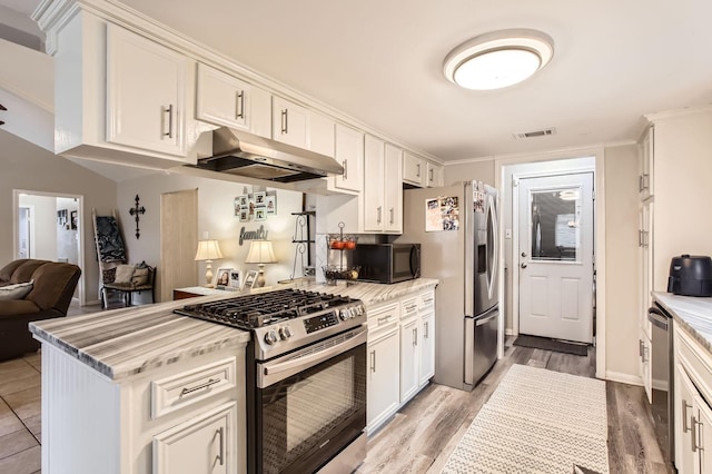 24610 Long Trail Ln, Houston, TX 77336 - kitchen with appliances with stainless steel finishes, under cabinet range hood, white cabinets, open floor plan, and light wood finished floors