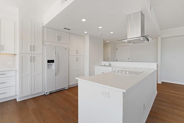 2001 Holcombe Blvd Unit 1605, Houston, TX 77030 - kitchen featuring white appliances, range hood, dark wood-type flooring, white cabinets, and recessed lighting