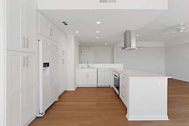 2001 Holcombe Blvd Unit 1605, Houston, TX 77030 - kitchen with white appliances, a sink, a peninsula, island exhaust hood, and recessed lighting