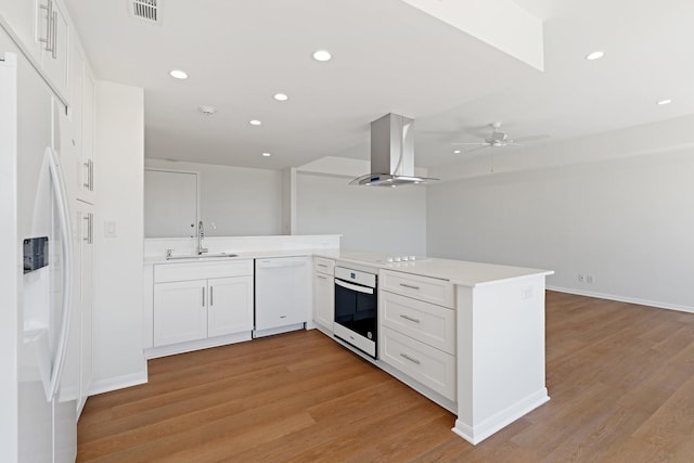 2001 Holcombe Blvd Unit 1605, Houston, TX 77030 - kitchen with white appliances, island range hood, a sink, ceiling fan, and light wood-style flooring