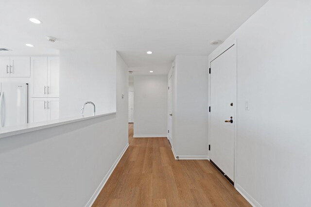 2001 Holcombe Blvd Unit 1605, Houston, TX 77030 - corridor with light wood finished floors, recessed lighting, baseboards, and a sink