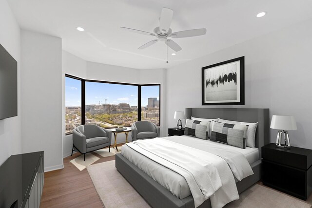 2001 Holcombe Blvd Unit 1605, Houston, TX 77030 - bedroom with recessed lighting, light wood finished floors, a city view, a ceiling fan, and baseboards