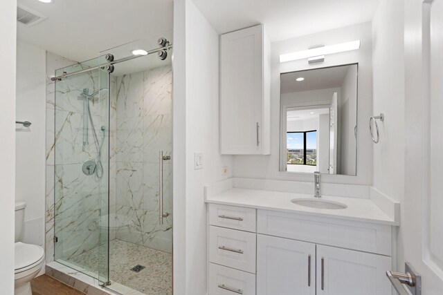 2001 Holcombe Blvd Unit 1605, Houston, TX 77030 - bathroom featuring toilet, a marble finish shower, vanity, and recessed lighting