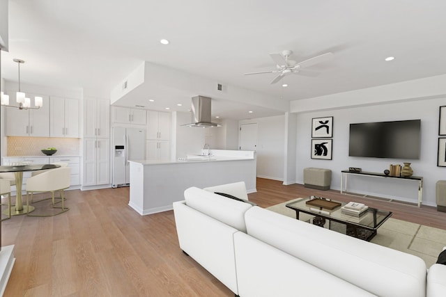2001 Holcombe Blvd Unit 1605, Houston, TX 77030 - living room featuring a ceiling fan, a chandelier, recessed lighting, and light wood-type flooring