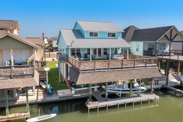 1815 Tiki Dr, Tiki Island, TX 77554 - rear view of property featuring a deck with water view and a shingled roof