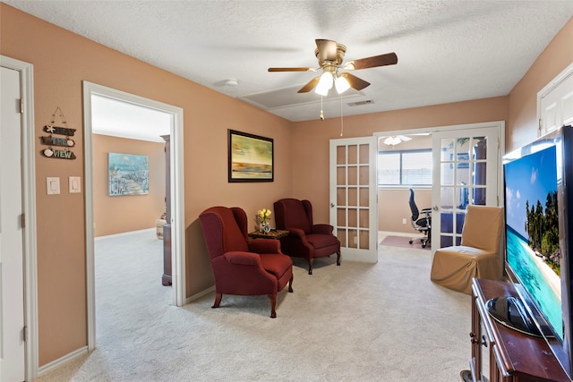 1815 Tiki Dr, Tiki Island, TX 77554 - sitting room with french doors, carpet flooring, ceiling fan, and a textured ceiling