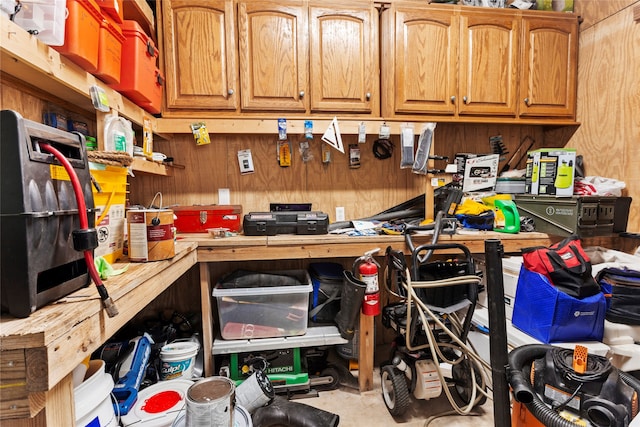 1815 Tiki Dr, Tiki Island, TX 77554 - kitchen with concrete floors, light countertops, wood walls, and brown cabinetry