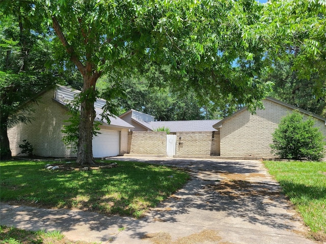 11514 Chetman Dr, Houston, TX 77065 - view of front of home with brick siding, concrete driveway, an attached garage, and a front lawn