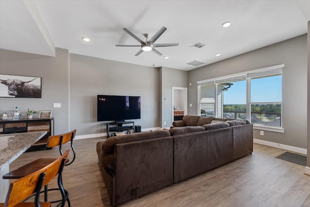 770 Dogberry Ct, Conroe, TX 77304 - living room featuring baseboards, ceiling fan, light wood-style flooring, and recessed lighting
