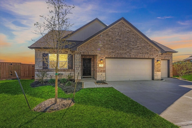 770 Dogberry Ct, Conroe, TX 77304 - view of front of property with brick siding, driveway, an attached garage, stone siding, and roof with shingles